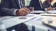 © Malika - Business consultants delving into financial reports and market graphs. Strategic Analysis