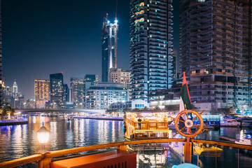 Wall Mural - Night Walk On Tourist Boat, Sightseeing Boat Sailing On Dubai Marina. Night View Of Dubai Marina Is District in Dubai, United Arab Emirates.