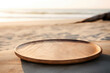 Empty wooden plate on sand beach at sunset background, shallow depth of field. High quality photo