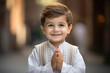 Cute indian little boy smiling and doing namaste or praying pose