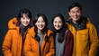 © DesignVectX - A family of four of Asian descent smiling together.