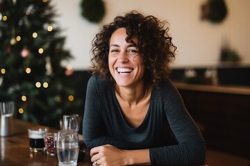 Poster - Portrait of happy young woman sitting in cafe at christmas time