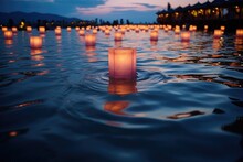 Glowing Lanterns Floating On Water At Dusk