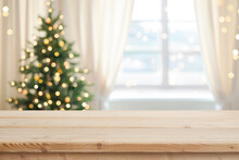 Desk Space In Front Of Window With Christmas Tree Background
