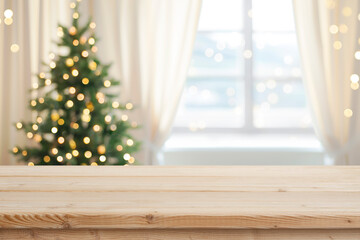 Wall Mural - desk space in front of window with christmas tree background
