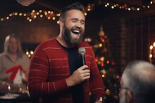Happy Man Singing Into A Microphone At A Christmas Dinner Party.