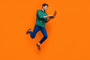 Wall Mural - Full length photo of web developer businessman jump netbook user gadget entrepreneur write python code isolated on orange color background