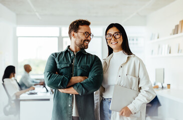 Poster - Two business people standing together in an office