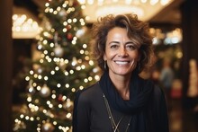 Portrait Of Happy Mature Woman With Christmas Tree In The Background