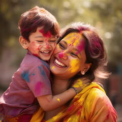 indian holi festival mother holding son.