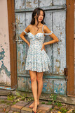 Fototapeta Konie - Young beautiful woman in summer dress standing against old door.