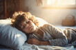 © MNStudio - Sad tired boy struggling to get up in the morning. Little sleepy child didn't get enough sleep at night. Waking a child to school.