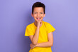 Photo of cheerful nice boy pupil wear yellow trendy clothes arm touch face decide solve question isolated on purple color background