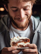 © Svetlana - Happy man biting cream cake in the cafe closeup