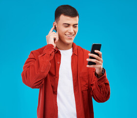 Aufkleber - Man, earphones and smile with phone for music streaming in studio and happy by blue background. Asian male model, searching online and smartphone while listening to radio, song and audio or podcast
