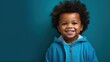 An animated portrait of a joyful child with curly hair, laughing heartily against a serene blue backdrop. Ideal for child care, happiness, or early education promotions.