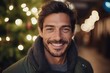 Portrait of handsome young man smiling in front of christmas tree