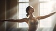 Ballet dancer stretching in a sunlit studio