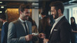 Two businessmen exchange business cards with smiles