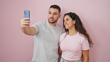 Poster - Man and woman couple having video call smiling over isolated pink background