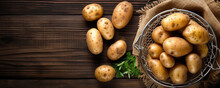 Potato On Rustic Wooden Background With Green Leafs