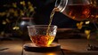 © JW Studio - Pouring black tea into glass cup on wooden table on black zen style background.