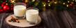 Homemade eggnog with cinnamon in glass on wooden table, traditional Christmas dessert treat.