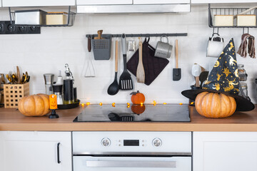 Wall Mural - Decor of the white classic kitchen with pumpkins for Halloween and harvest. Autumn mood in the home interior, modern loft style.