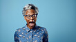 Shocked old senior african american woman wearing casual clothes isolated on blue background amazed and surprised looking at camera