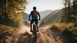 silhouette of a cyclist descending a hill on a mountain bike in dust and smoke