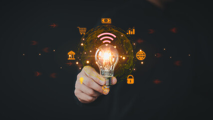 Poster - Businessman holding a light bulb with virtual technology global internet connection. Financial and banking, online shopping, payment, big data. Communication internet connect application technology.