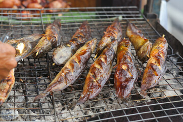 Wall Mural - fresh grilled fish is being prepared on the street in Vietnam