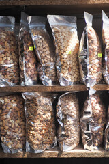Canvas Print - close up of many mixed nuts in packet at shelf 