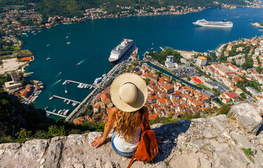 Wall Mural - traveler young female looking at panoramic view of kotor bay- travel, tour tourism, vacation in mont