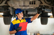 © anekoho - repairman and technician in car garage service in blue uniform