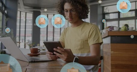 Poster - Animation of letter in open envelope icons over biracial man scrolling on digital tablet in cafes