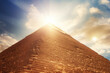 The Top Of The Great Egyptian Pyramid Against A Background Of The Sky With Sun Flares Created Using Artificial Intelligence