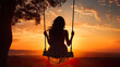 © Vlad - The silhouette of a woman on a swing outdoors during sunset, back view