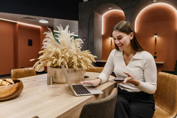 The financier is a happy person in the company. A female architect responds to a client's email. A freelancer uses a laptop device to communicate with the team online.