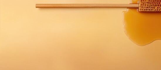 Poster - Wooden stick and golden honey on isolated pastel background Copy space