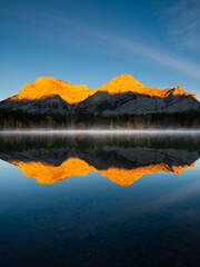 Wall Mural - mountain landscape at dawn. foggy morning. lake and forest in a mountain valley at dawn.reflections 