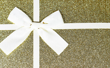 Wall Mural - golden glitter gift box with beige ribbon, holiday concept 