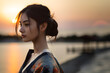 Portrait of a young beautiful japanese woman in Kimono with a nature view at sunset, Asian culture