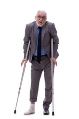 Wall Mural - Old businessman with crutches isolated on white