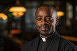 © Michael - Portrait of a smiling African American Catholic priest in robes. Copy space for text