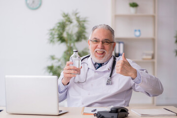 Old male doctor working in the clinic