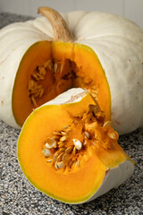 Wall Mural - Fresh Flat White Boer Pumpkin and a wedge with seed close up