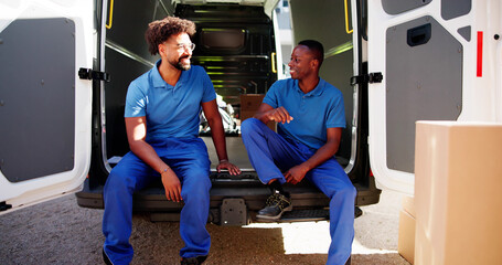 Happy Young Movers And Van Truck