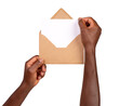 © photka - Man holding a brown paper envelope with a blank letter isolated on white or transparent background