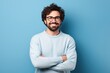 © pham - A confident man with a beard and glasses standing with his arms crossed